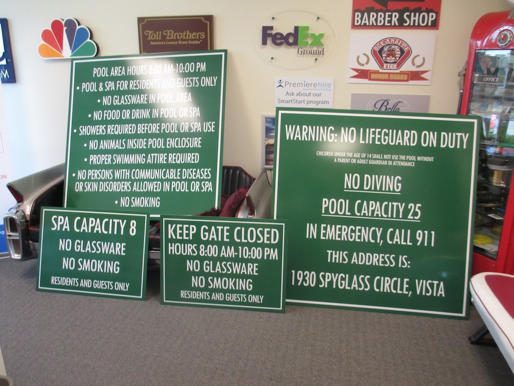 Pool Signs waiting to be installed in an HOA pool