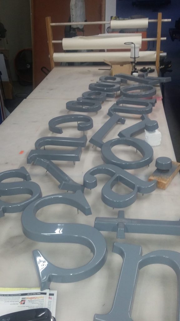 3d lettering dimensional letters being painted