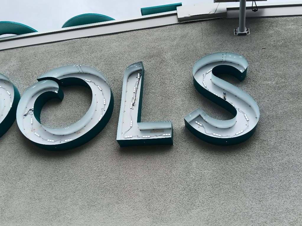 Close up of the open GL POOLS Sign.